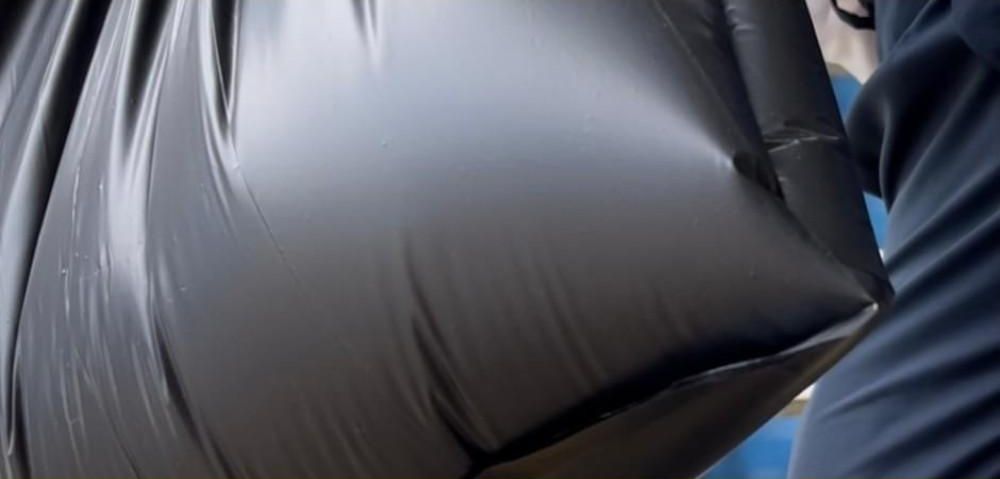 Black bag filled to the top with water